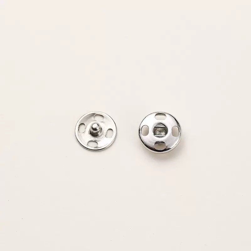 Silver-tone sew-on snap button finish reference; specifications to be confirmed